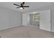 Spacious bedroom with a ceiling fan and view to another room with lots of light from the windows at 115 Rockhurst Chase, Tyrone, GA 30290