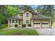 Charming two-story home with attached two-car garage and well-maintained landscaping at 115 Rockhurst Chase, Tyrone, GA 30290