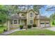 Charming two-story home with attached two-car garage and well-maintained landscaping at 115 Rockhurst Chase, Tyrone, GA 30290