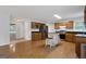 Open kitchen features wood cabinets, stainless steel appliances, and a central island with seating at 115 Rockhurst Chase, Tyrone, GA 30290