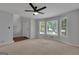 Open Living room with lots of natural light from the large windows on the side wall at 115 Rockhurst Chase, Tyrone, GA 30290