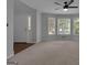 Open Living room with lots of natural light from the large windows on the side wall at 115 Rockhurst Chase, Tyrone, GA 30290