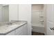 Bathroom featuring granite counters, white sink and cabinets, and tub and shower combo at 275 Oliver Dr, Locust Grove, GA 30248
