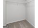 Walk-in closet with carpet, white shelving, and ample storage space at 275 Oliver Dr, Locust Grove, GA 30248