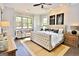 A luxury main bedroom with a sitting area and a large window offering a scenic view at 25 Oak Rd, Locust Grove, GA 30248