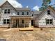 Exterior of a new house in the framing stage with moisture barrier installed at 25 Oak Rd, Locust Grove, GA 30248