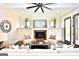 Comfortable living room featuring a fireplace, built-in cabinets, and french doors at 25 Oak Rd, Locust Grove, GA 30248