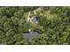 Aerial view of secluded property showcasing a home, pond, and wooded surroundings at 300 Peggy Cole Bridge Rd, Villa Rica, GA 30180
