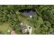 Aerial view of home, pond, green grass and many mature trees at 300 Peggy Cole Bridge Rd, Villa Rica, GA 30180