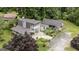 Aerial view showcases house with two-story porch, landscaped yard, and driveway at 300 Peggy Cole Bridge Rd, Villa Rica, GA 30180