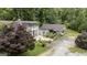 Aerial view of a charming two-story home with a covered porch and lush greenery at 300 Peggy Cole Bridge Rd, Villa Rica, GA 30180