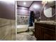Bathroom showcasing tiled floors, tub, toilet, vanity, and updated mirror at 300 Peggy Cole Bridge Rd, Villa Rica, GA 30180