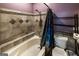 Bathroom with tiled walls, a tub, and a toilet at 300 Peggy Cole Bridge Rd, Villa Rica, GA 30180