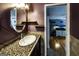 A bathroom with a sink and vanity with a view into an adjacent room at 300 Peggy Cole Bridge Rd, Villa Rica, GA 30180