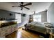 Bedroom with hardwood floors, ceiling fans, and multiple aquariums at 300 Peggy Cole Bridge Rd, Villa Rica, GA 30180
