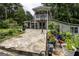 Charming home with a welcoming stone patio and cozy second-story balcony, surrounded by lush greenery at 300 Peggy Cole Bridge Rd, Villa Rica, GA 30180