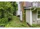 The side of the house features an AC unit and drain, complemented by lush greenery at 300 Peggy Cole Bridge Rd, Villa Rica, GA 30180