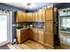 Charming kitchen featuring wood cabinets, a mosaic tile backsplash, and a light-filled window at 300 Peggy Cole Bridge Rd, Villa Rica, GA 30180