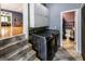 Functional laundry room with gray cabinets and a laundry sink that is conveniently located near the stairs at 300 Peggy Cole Bridge Rd, Villa Rica, GA 30180