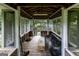 Covered porch overlooking the water, featuring a wooden deck and screened windows for enjoying outdoor views at 300 Peggy Cole Bridge Rd, Villa Rica, GA 30180