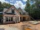 New home construction showing the framing of a two story structure with front porch in wooded area at 651 Burg Rd, Locust Grove, GA 30248