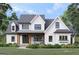 Charming new construction home featuring a farmhouse design with a welcoming front porch and manicured lawn at 651 Burg Rd, Locust Grove, GA 30248