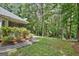 Lush backyard featuring a manicured lawn and a pathway leading to a wooded area at 40 Riverside Pkwy, Sharpsburg, GA 30277