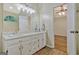 Bathroom with a double sink vanity, decorative mirror, and wood floors at 40 Riverside Pkwy, Sharpsburg, GA 30277