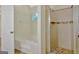 Bathroom showcasing a tub and shower, with an arch window and decorative tile at 40 Riverside Pkwy, Sharpsburg, GA 30277