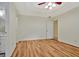 Open bedroom featuring wood flooring, neutral walls, and a ceiling fan at 40 Riverside Pkwy, Sharpsburg, GA 30277