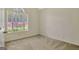 Inviting bedroom with a vaulted ceiling, large window, and neutral carpeting at 40 Riverside Pkwy, Sharpsburg, GA 30277