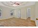 Spacious bedroom featuring wood flooring, large windows, and a tray ceiling with ceiling fan at 40 Riverside Pkwy, Sharpsburg, GA 30277