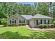 Charming single-story home with a well-manicured lawn and lush landscaping at 40 Riverside Pkwy, Sharpsburg, GA 30277