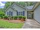 Close up of front lawn and bushes of a single story home with lovely green foliage at 40 Riverside Pkwy, Sharpsburg, GA 30277