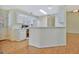 Bright kitchen featuring white cabinets, modern appliances, and wood-style flooring at 40 Riverside Pkwy, Sharpsburg, GA 30277