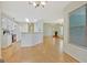Open living space with hardwood floors, fireplace, and white kitchen with modern appliances at 40 Riverside Pkwy, Sharpsburg, GA 30277