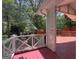 Inviting red back porch, perfect for outdoor relaxation and enjoying the serene backyard view at 2306 Old Lower River Rd, Douglasville, GA 30135
