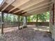 Backyard of the home with covered parking and natural landscaping creates a secluded outdoor space at 2306 Old Lower River Rd, Douglasville, GA 30135