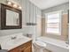 Bright bathroom with a tub, vanity, and ample space, providing a comfortable and functional area at 2306 Old Lower River Rd, Douglasville, GA 30135