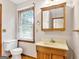 Traditional bathroom with a wood vanity, mirrored medicine cabinet and neutral wall color at 2306 Old Lower River Rd, Douglasville, GA 30135