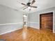 Spacious bedroom with wood floors, a ceiling fan, and closet, providing a serene environment at 2306 Old Lower River Rd, Douglasville, GA 30135