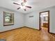 Bright bedroom with wood floors, ceiling fan, large window and ensuite access, creating a relaxing atmosphere at 2306 Old Lower River Rd, Douglasville, GA 30135