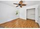 Bright bedroom with wood floors, ceiling fan, large window and spacious closet, creating a relaxing atmosphere at 2306 Old Lower River Rd, Douglasville, GA 30135