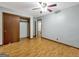Bedroom featuring a ceiling fan, hardwood floors, a sliding closet door, and an exterior view at 2306 Old Lower River Rd, Douglasville, GA 30135