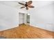 Bedroom featuring hardwood floors, neutral walls, a ceiling fan, and a closet at 2306 Old Lower River Rd, Douglasville, GA 30135