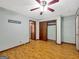 Large bedroom with wood floors, a ceiling fan, closet, and natural light, offering a restful space at 2306 Old Lower River Rd, Douglasville, GA 30135