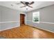 Comfortable bedroom with wood floors, a ceiling fan, closet, and natural light, offering a restful space at 2306 Old Lower River Rd, Douglasville, GA 30135