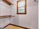 Walk-in closet features a window for natural light and wooden shelving at 2306 Old Lower River Rd, Douglasville, GA 30135