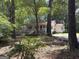 Exterior view of home surrounded by mature trees and lush greenery at 2306 Old Lower River Rd, Douglasville, GA 30135