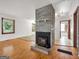 Living area features a brick fireplace, wood flooring, and views to the bathroom at 2306 Old Lower River Rd, Douglasville, GA 30135